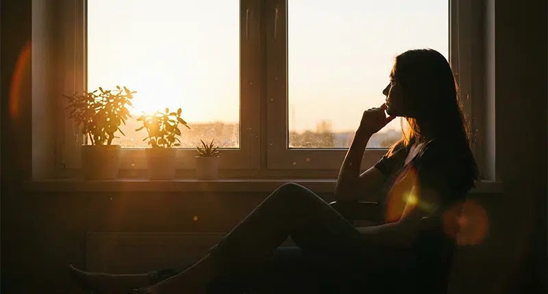 Como o silêncio ajuda a ouvir a sua espiritualidade 1 Silhueta de mulher em momento de contemplação e silêncio, representando o portal espiritual.